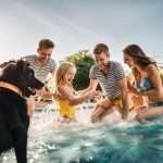 A family enjoying swimming in the pool.