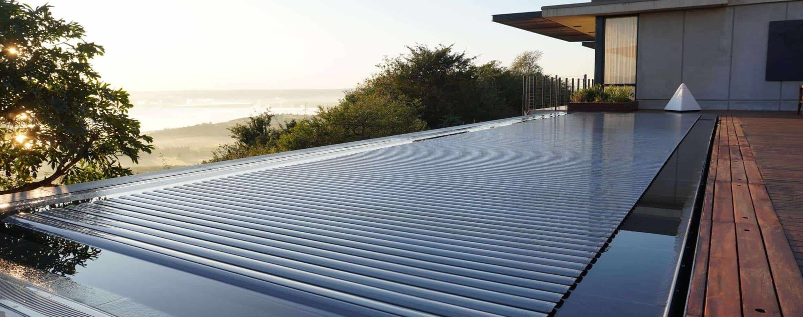 A swimming pool on a deck with a view of the ocean.